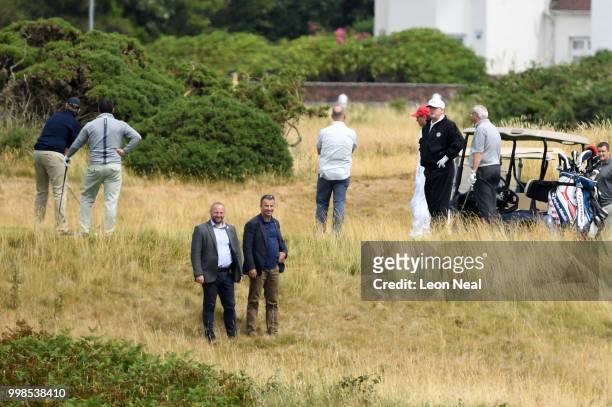 President Donald Trump watches as his son Eric Trump takes his turn playing golf at Trump Turnberry Luxury Collection Resort during the President's...