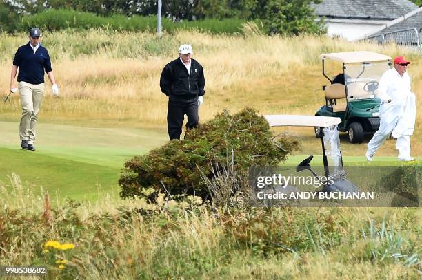 President Donald Trump walks during a round of golf on the Ailsa course at Trump Turnberry, the luxury golf resort of US President Donald Trump, in...