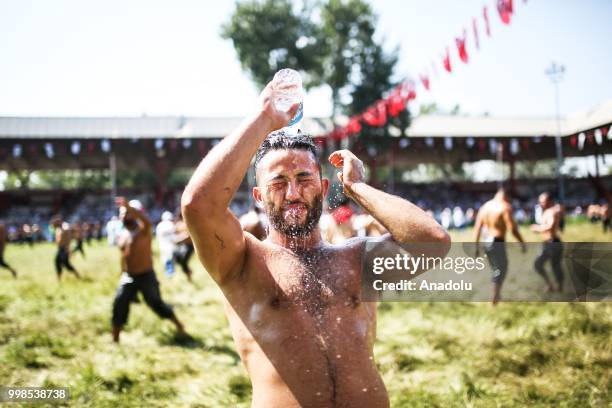 Wrestler cools off with water after competing on the second day of the 657th annual Kirkpinar Oil Wrestling Festival in Sarayici near Edirne, Turkey...