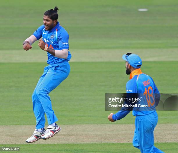 Umesh Yadav of India celebrates taking the wicket of Jos Buttler of England during the 2nd Royal London One day International match between England...