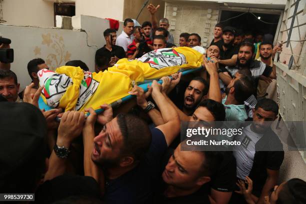 Palestinian mourners and relatives carry the body of 15-year-old killed Palestinian protester Othman Rami Halles during his funeral east of Gaza City...