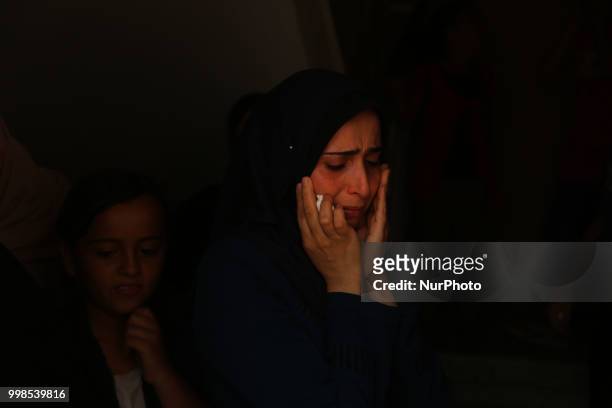 Palestinians and relatives mourn over the death of 15-year-old protester Othman Rami Halles during his funeral east of Gaza City on July 14, 2018. A...