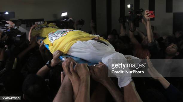Palestinian mourners and relatives carry the body of 15-year-old killed Palestinian protester Othman Rami Halles during his funeral east of Gaza City...