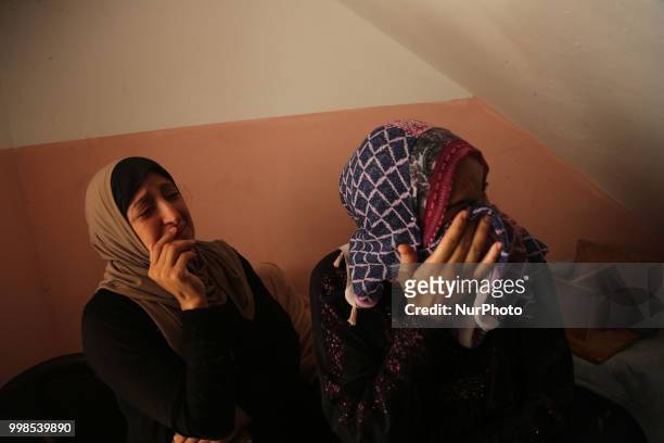 Palestinians and relatives mourn over the death of 15-year-old protester Othman Rami Halles during his funeral east of Gaza City on July 14, 2018. A...