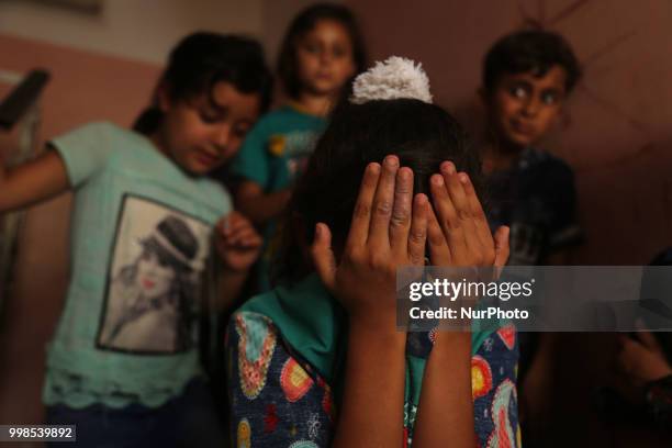 Palestinians and relatives mourn over the death of 15-year-old protester Othman Rami Halles during his funeral east of Gaza City on July 14, 2018. A...