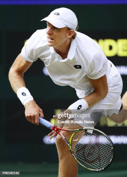 Kevin Anderson of South Africa serves against John Isner of the United States during a Wimbledon semifinal match in London on July 13, 2018. Anderson...