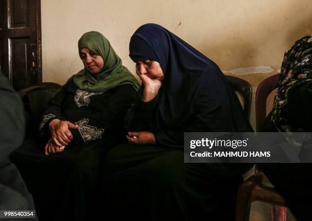 Graphic content / Relatives of 15-year-old Palestinian protester Othman Rami Halles mourn during his funeral in Gaza City on July 14, 2018. - The...