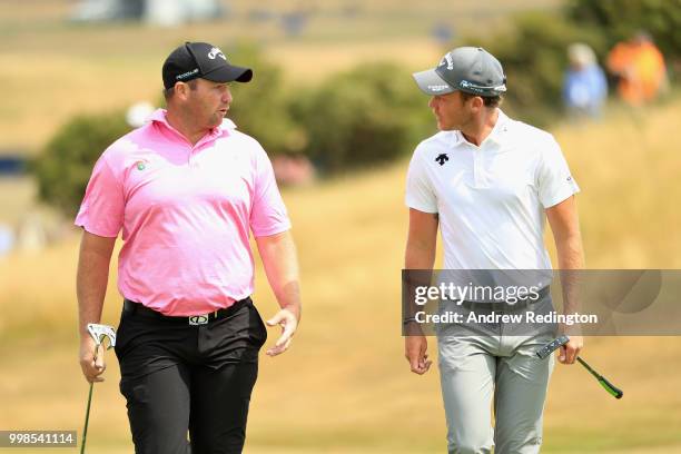 Danny Willett of England talks with Duncan Stewart of Scotland on hole one during day three of the Aberdeen Standard Investments Scottish Open at...