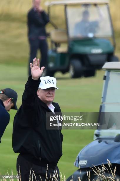 President Donald Trump gestures as he walks during a round of golf on the Ailsa course at Trump Turnberry, the luxury golf resort of US President...