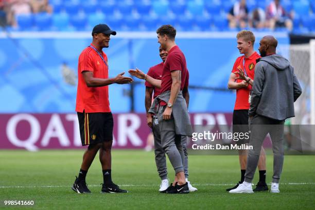 Vincent Kompany and Kevin De Bruyne of Belgium talk to John Stones, Raheem Sterling and Fabian Delph of England during a pitch inspection prior to...