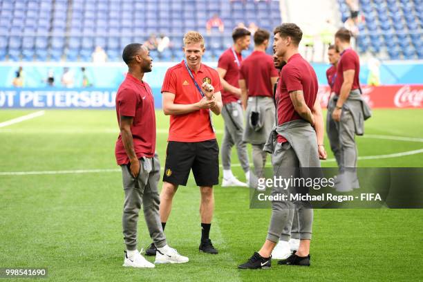 Raheem Sterling of England speaks with Kevin De Bruyne of Belgium and John Stones of England during a pitch inspection prior to the 2018 FIFA World...