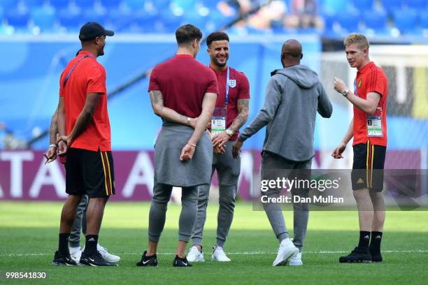 Vincent Kompany and Kevin De Bruyne of Belgium talk to John Stones, Kyle Walker and Fabian Delph of England during a pitch inspection prior to the...