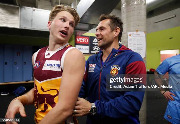 An injured Luke Hodge of the Lions celebrates a goal Alex Witherden of the Lions during the 2018 AFL round 17 match between the Hawthorn Hawks and...