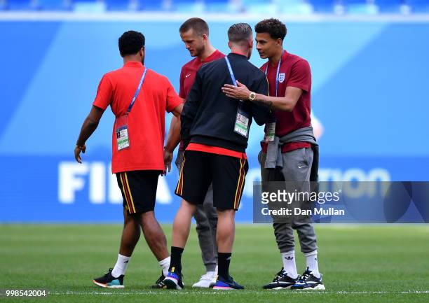 Mossua Dembele, and Toby Alderweireld of Belgium speak to Tottenham Hotspur teammates, Eric Dier, and Dele Alli of England during a pitch inspection...