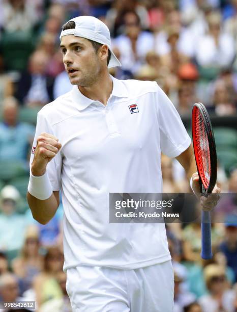 John Isner of the United States reacts after winning a point against Kevin Anderson of South Africa during a Wimbledon semifinal match in London on...