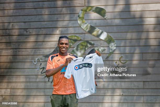 Joel Asoro holds a home shirt after Swansea City Unveil New Signing Joel Asoro at The Fairwood Training Ground on July 13, 2018 in Swansea, Wales.