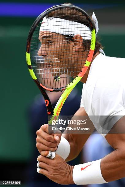 Rafael Nadal of Spain returns against Novak Djokovic of Serbia during their Men's Singles semi-final match on day twelve of the Wimbledon Lawn Tennis...