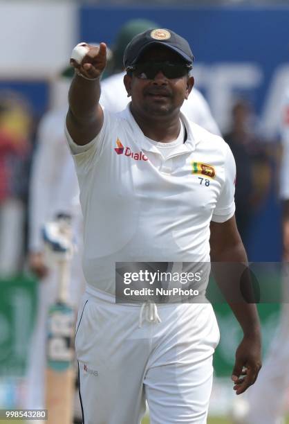 Sri Lankan cricketer Rangana Herath gestures to his dressing room during the 3rd day's play in the first Test cricket match between Sri Lanka and...