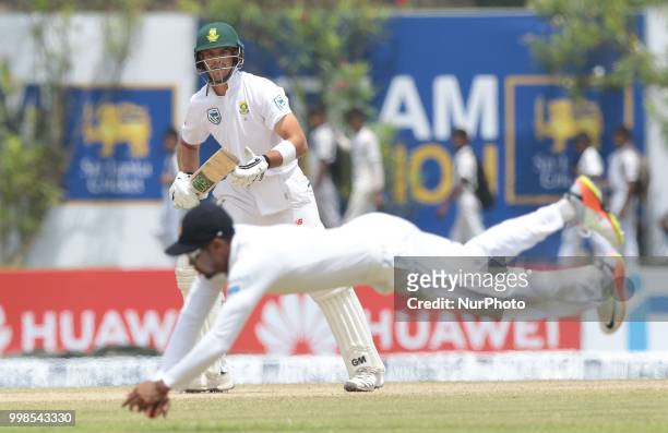 South African cricketer Aiden Markram looks on as Sri Lanka's Danushka Gunathilaka dives in to stop the ball during the 3rd day's play in the first...