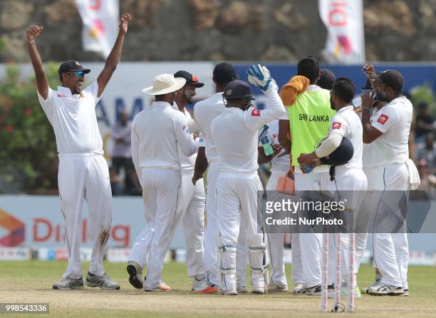 Sri Lankan cricket captain Suranga Lakmal celebrates with his team mates during the 3rd day's play in the first Test cricket match between Sri Lanka...