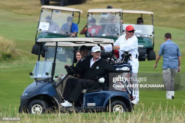 President Donald Trump sits in a golf cart as he plays a round of golf on the Ailsa course at Trump Turnberry, the luxury golf resort of US President...