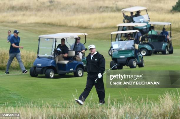 President Donald Trump walks as he plays a round of golf on the Ailsa course at Trump Turnberry, the luxury golf resort of US President Donald Trump,...
