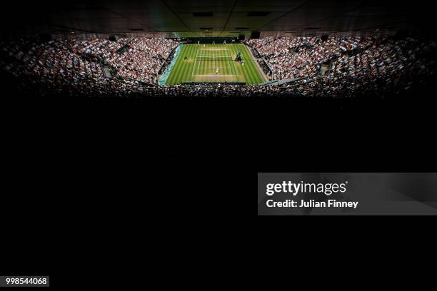 Rafael Nadal of Spain serves against Novak Djokovic of Serbia during their Men's Singles semi-final match on day twelve of the Wimbledon Lawn Tennis...