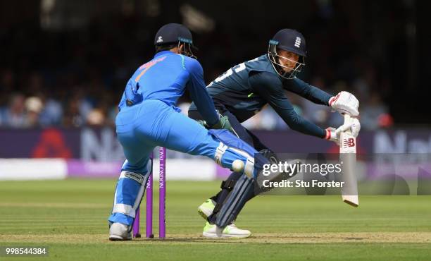 England batsman Joe Root flicks a ball to the boundary watched by MS Dhoni during the 2nd ODI Royal London One Day International match between...