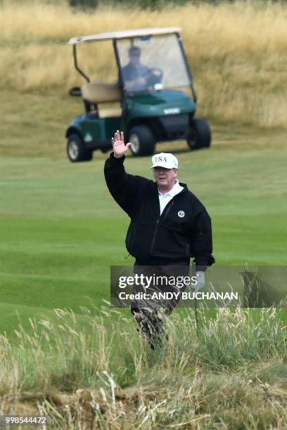 President Donald Trump gestures as he plays a round of golf on the Ailsa course at Trump Turnberry, the luxury golf resort of US President Donald...