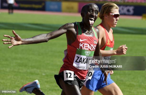 Edward Zakayo Pingua of Kenia reacts on the finish-line with Simen Halle Haugen of Norway during the men's 5000 metres final at the 2018 IAAF World...