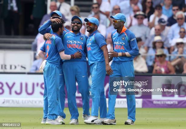 India's Yuzvendra Chahal celebrates dismissing England's Moeen Ali, caught out by Rohit Sharma during the second Royal London one day international...