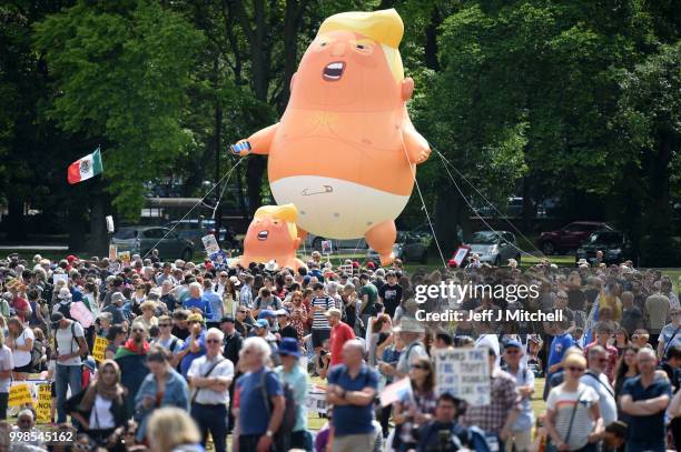 The Baby Trump Balloon floats in the middle of crowds holding anti-Trump signs while the U.S. President is visiting Trump Turnberry Luxury Collection...