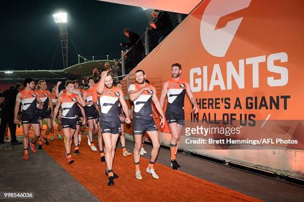 Callan Ward of the Giants leads his team to the sheds after victory during the round 17 AFL match between the Greater Western Sydney Giants and the...