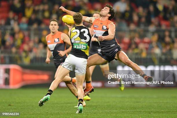 Tim Taranto of the Giants spoils a Kane Lambert of the Tigers mark during the round 17 AFL match between the Greater Western Sydney Giants and the...