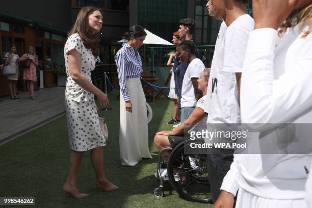 Catherine, Duchess of Cambridge and Meghan, Duchess of Sussex meet Wheelchair competitors Lucy Shuker of Great Britain and KG Montjane and South...