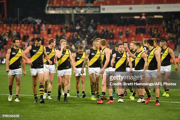 Tigers players show their dejection after defeat during the round 17 AFL match between the Greater Western Sydney Giants and the Richmond Tigers at...