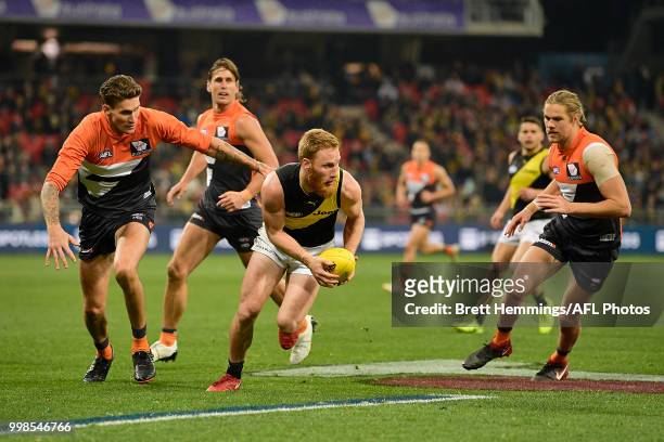 Nick Vlastuin of the Tigers controls the ball during the round 17 AFL match between the Greater Western Sydney Giants and the Richmond Tigers at...