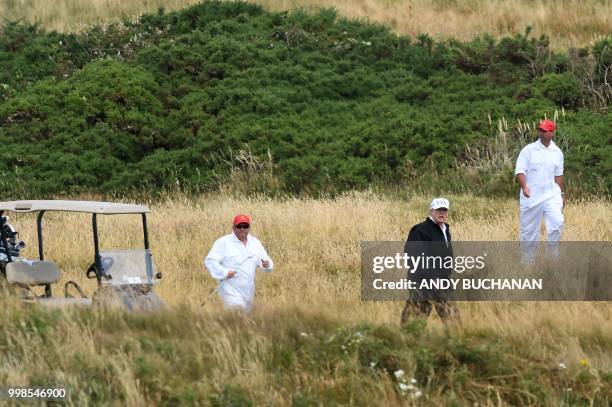 President Donald Trump walks as he plays a round of golf on the Ailsa course at Trump Turnberry, the luxury golf resort of US President Donald Trump,...