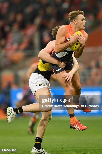 Zac Langdon of the Giants is tackled during the round 17 AFL match between the Greater Western Sydney Giants and the Richmond Tigers at Spotless...