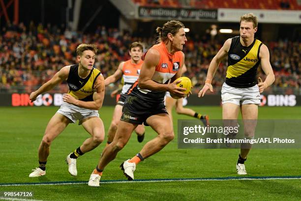 Ryan Griffen of the Giants runs with the ball during the round 17 AFL match between the Greater Western Sydney Giants and the Richmond Tigers at...