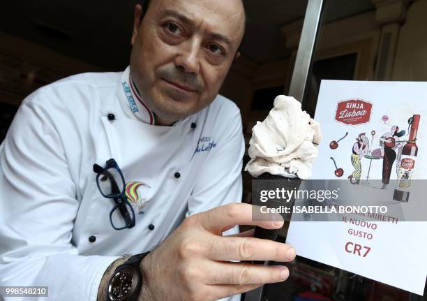 Mister Leonardo, from Miretti's ice-cream shop in downtown Turin, pose with the new ice-cream taste called CR7 on July 14, 2018. - This ice-cream,...