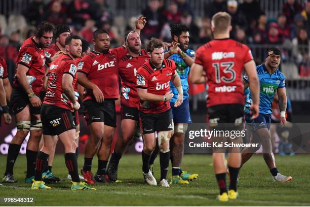 Samuel Whitelock, Ryan Crotty, Andrew Makalio, Tim Perry and Mitchell Drummond of the Crusaders react during the round 19 Super Rugby match between...