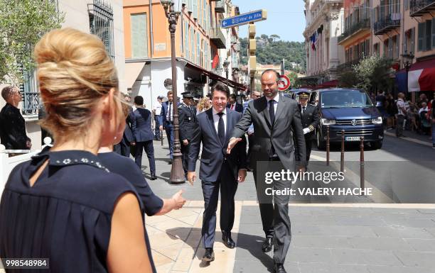 French Prime Minister Edouard Philippe walks with The Mayor of Nice Christian Estrosi as he arrives in Nice on July 14 to attend a ceremony for the...