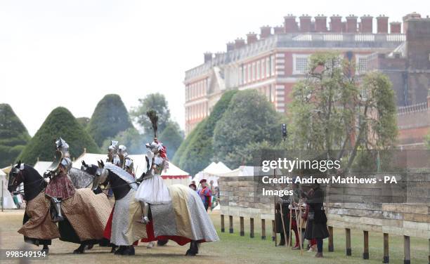 Knights line up in front of the Royal box before they joust in a tournament during the Tudor Joust Weekend at Hampton Court Palace, in Richmond upon...