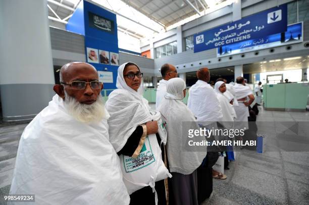 Muslim pilgrims go through passport control upon their arrival at Jeddah airport on July 14 prior to the start of the annual Hajj pilgrimage in the...