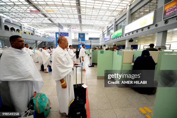 Muslim pilgrims go through passport control upon their arrival at Jeddah airport on July 14 prior to the start of the annual Hajj pilgrimage in the...