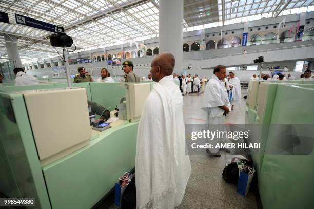 Muslim pilgrims go through passport control upon their arrival at Jeddah airport on July 14 prior to the start of the annual Hajj pilgrimage in the...