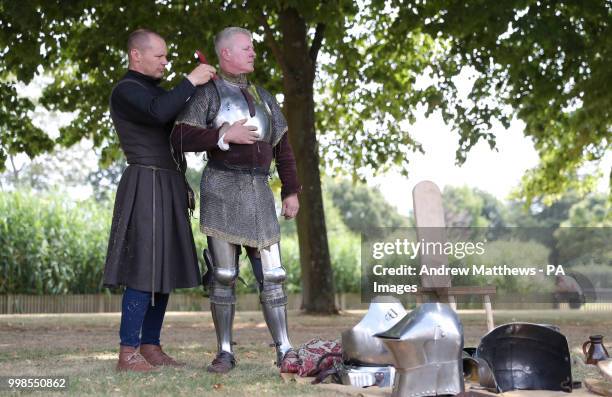 Knight has his armour fitted before the start of the jousting tournament during the Tudor Joust Weekend at Hampton Court Palace, in Richmond upon...