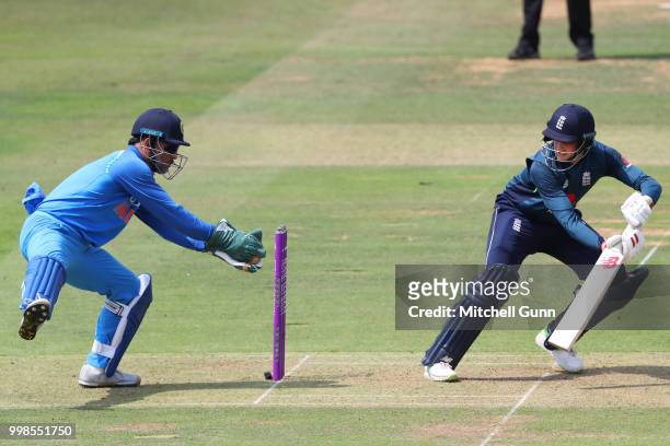 Joe Root of England plays a shot as MS Dhoni of India keeps wicket during the 2nd Royal London One day International match between England and India...
