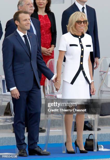 French President Emmanuel Macron and his wife Brigitte Macron attend the traditional Bastille Day military parade on the Champs-Elysees on July 14,...